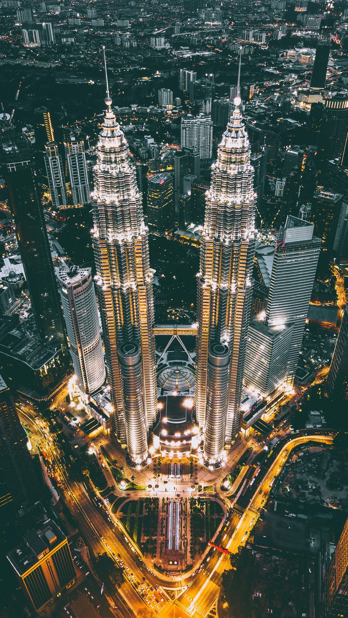 The Petronas Twin Towers viewed from ground level, conveying their soaring scale