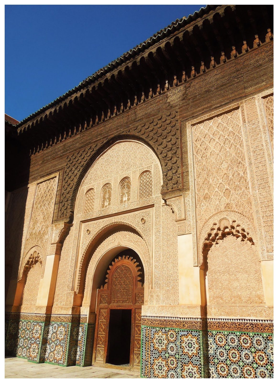 Ornate Islamic geometric doorway in a historic madrasa