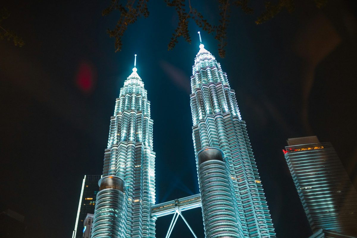 Wide night panorama of the Kuala Lumpur skyline with the Petronas Towers