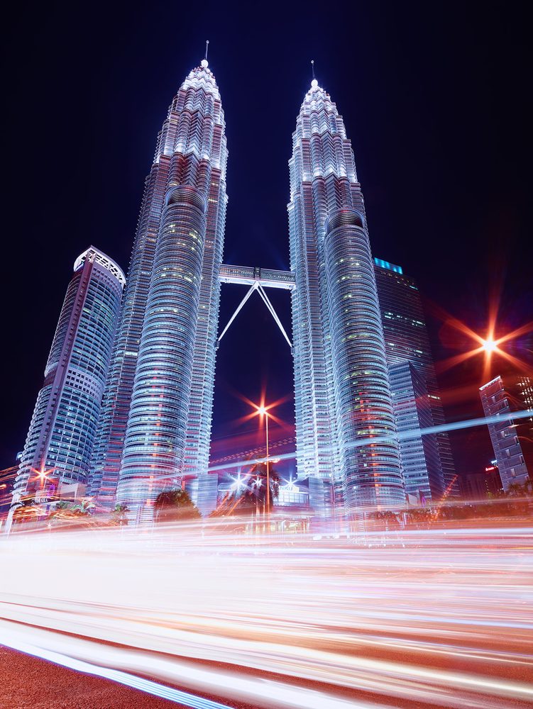 Kuala Lumpur skyline at night with Petronas Towers and light trails