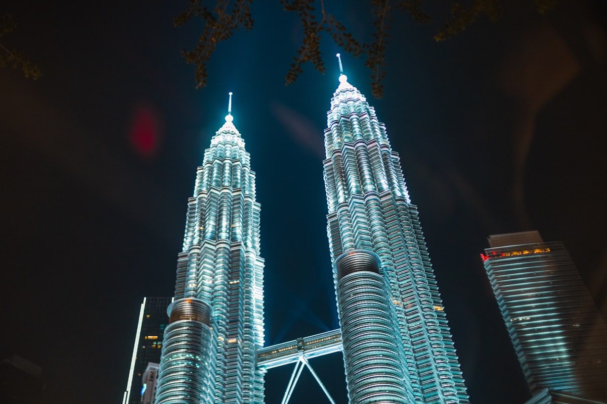 Wide landscape night view of the Petronas Twin Towers